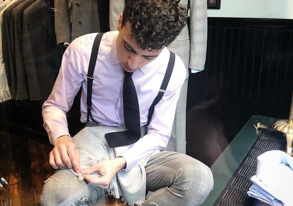 Tailor hand feathering a scarf