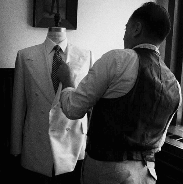 Tailor looking over a completed suit jacket