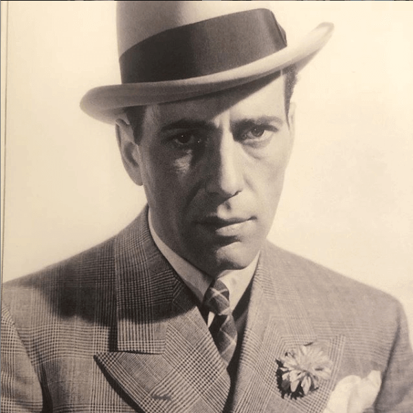 Old portrait photo of a man in a suit and hat