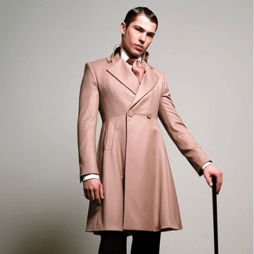 Model showing off a salmon overcoat