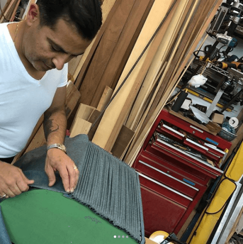 Man gathering up fabric into small pleats