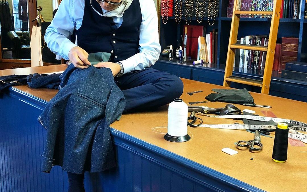 Robinson stitching a suit jacket