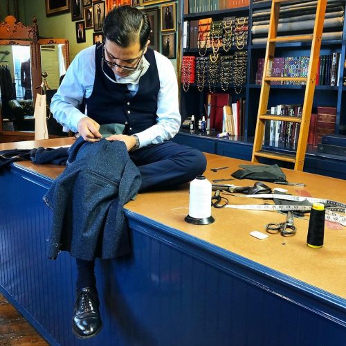 Robinson stitching a suit jacket
