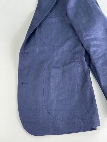 Side pocket view of blue suit jacket