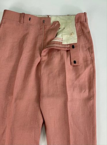 View of pant hooks, zipper and button on salmon dress pants