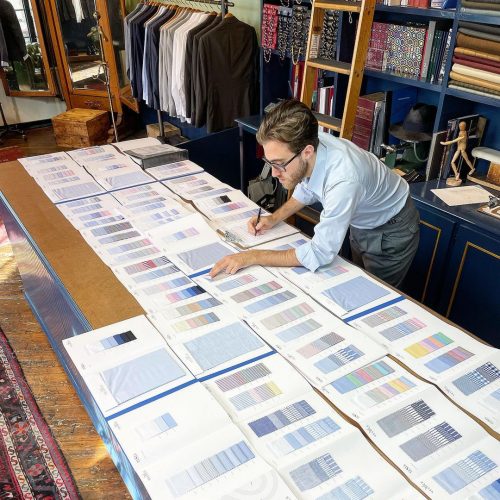 Tailor reviewing fabric types and colors