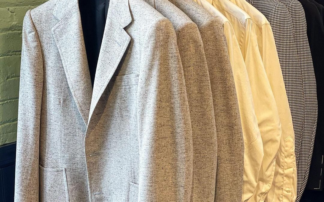 Suit jackets and collared shirts hanging inside the store