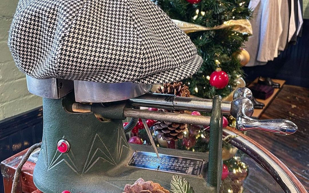 Black and white flat cap displayed among holiday decorations