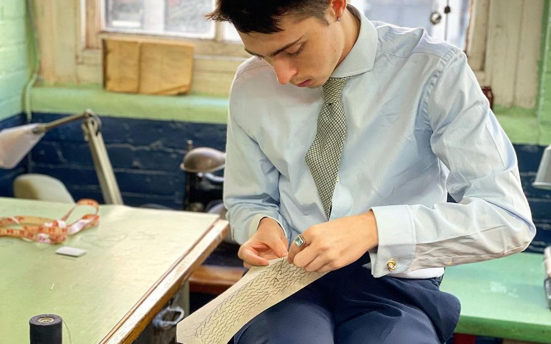 Tailor sewing a piece of fabric